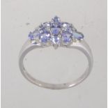 A hallmarked 9ct white gold tanzanite and diamond cluster ring. Hallmarked for Sheffield. Size T.