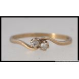 A hallmarked 9ct gold diamond ring with two cathedral set diamonds in a wrap over setting. Size M.