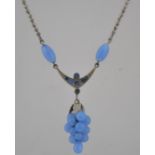 A vintage 1950s popcorn chain pendant necklace strung with a blue glass bead cluster in the form of