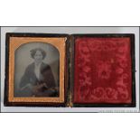 A 19th century Ambrotype photograph of a seated lady with hand written notation to the inside of