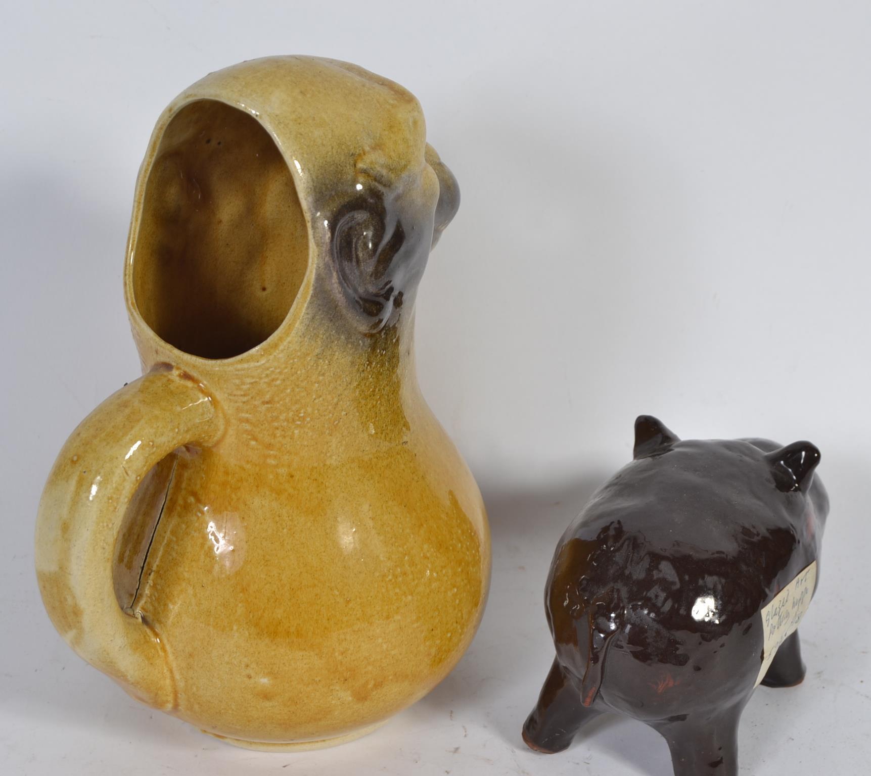 An unusual Victorian novelty jug in the form of a grotesque monkey along with a glazed pottery - Image 2 of 3
