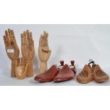 A group of 4 20th Century hand mannequins one being a smaller childs hand along with a group of