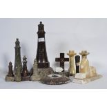 A group of graduating serpentine lighthouses along with a serpentine crucifix and various other