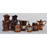 A group of Victorian copper lustre jugs along with some Toby jugs