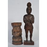 An early carved figure of a Centurion along with a carved African lady holding a basket