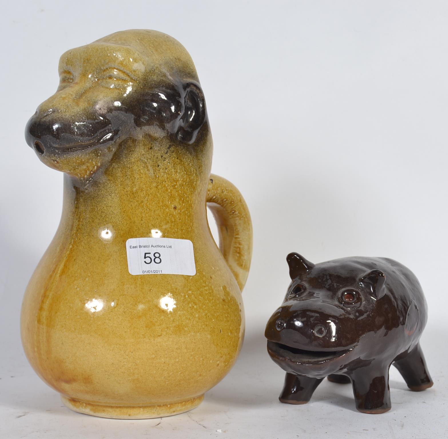 An unusual Victorian novelty jug in the form of a grotesque monkey along with a glazed pottery