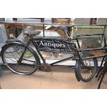 A vintage mid 20th century butchers bike with framework for a basket,