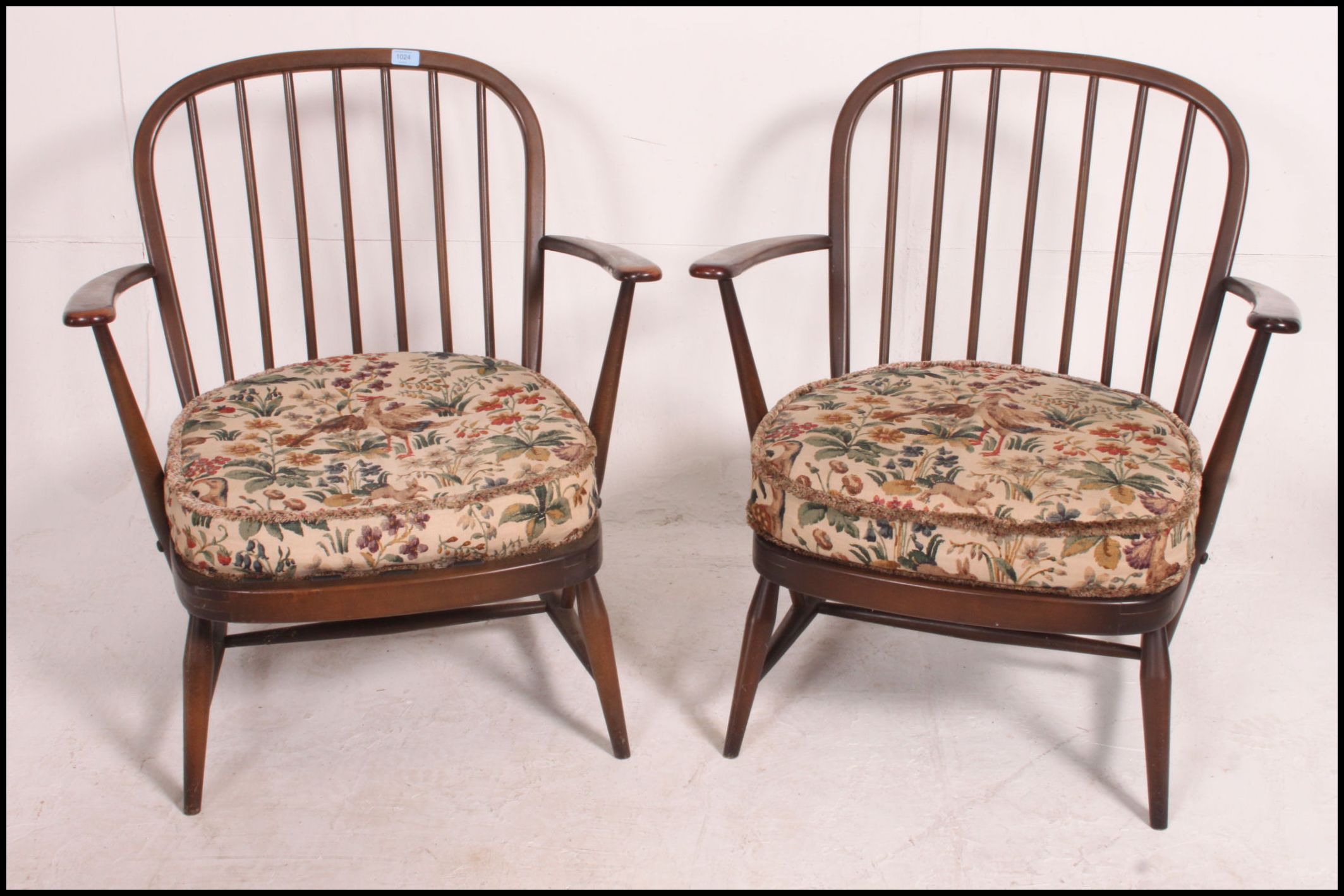 A pair of Ercol beech and elm windsor pattern armchairs complete with the cushions. - Image 2 of 4