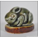 A Royal Doulton Stoneware Rabbit of an interesting small figure of a Rabbit with a green glaze on