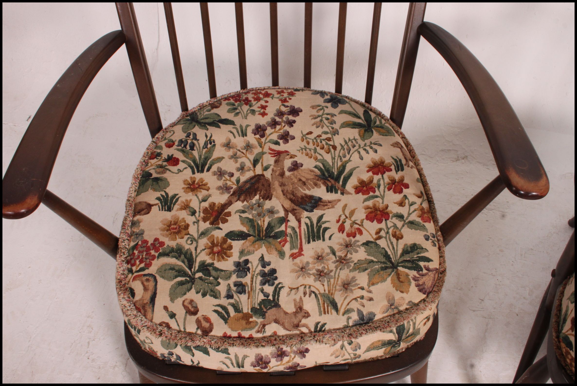 A pair of Ercol beech and elm windsor pattern armchairs complete with the cushions. - Image 4 of 4