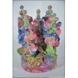 A Wade No 44 diorama floral bouquet of foxgloves being raised on plinth base and stamped to the