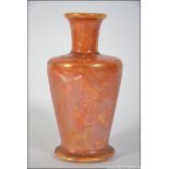 An early 20th Century Ruskin orange lustre glazed vase of tapering form with waisted neck being