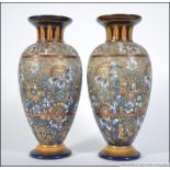 A Pair of Doulton Lambeth Art Nouveau stoneware glazes bases with trumpet flared tops with