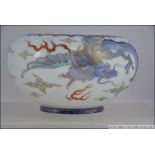 A Japanese porcelain bowl decorated in underglaze blue and enamels with 4 toe dragon.