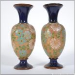 A Pair of Doulton Lambeth Art Nouveau stoneware glazes bases with trumpet flared tops over bulbous