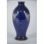 A small Doulton Lambeth Art Nouveau blue glaze vase of small form with impressed stamps to the base