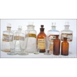 A collection of 19th and 20th century medicine apocathery bottles to include clear and brown glass,