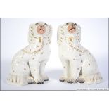A pair of early 20th century Staffordshire figurines of Spaniels - dogs ( see illustrations ).