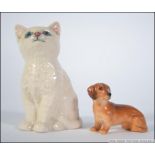 A Royal Doulton figurine of a cat together with a Royal Doulton figure of a dachshund.