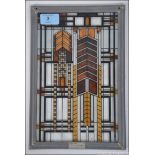 After Frank Lloyd-Wright a geometric coloured glass window hanging in leaded surround having plaque