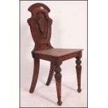 A Victorian mahogany hall chair raised o