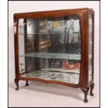 A 1950's walnut china display cabinet wi