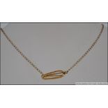 A 9ct gold brooch chain with shaped clip