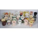 A collection of novelty egg cups to incl