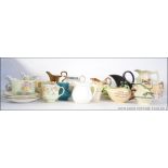A collection of ceramic creamers to incl