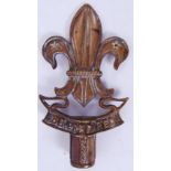 BRASS EMBLEM: A brass cane topper / emblem / standard knop in the form of the Fluer De Lys,