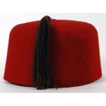 MILITARY ISSUE FEZ: A post WWII era 1955 military issue uniform fez hat. Red, with original tassle.