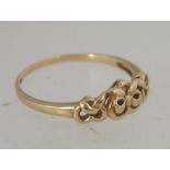 A hallmarked 9ct gold ring with bow and heart motif . Hallmarked Biringham. Size P.