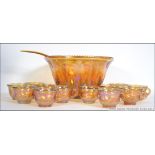 A vintage / retro 20th century Carnival glass punch bowl set to include the bowl cups and hooks