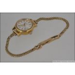 A ladies Rotary cocktail dress watch set to a 9ct gold hallmarked snake linked bracelet.