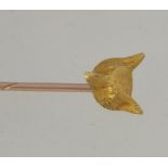 A 15ct gold stick / hat pin with fox head mount.