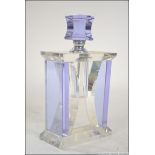 A glass art deco style perfume bottle having a screw top stopper with attached dabber.