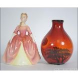 A Royal Doulton figurine entitled Debbie HN2400 together with a Poole pottery flambe bulbous vase.