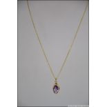 A 9ct gold and amethyst pendant being Birmingham hallmarked and of lozenge form. Weight 2.7g.