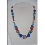 A Chinese / Tibetan silver, turquoise and agate stone set necklace.