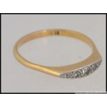 An 18ct gold and diamond ring being illusion set with 5 stones of graduating size approx 10-12 pnts.