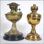 A pair of non matching early 20th century brass oil lamps. Measures: 32cms high.