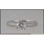 A silver 925 white metal and CZ engagement ring