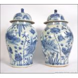 A large pair of Chinese blue and white Kang-xi oversized ginger jars complete with lids having