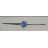 A Ladies Victorian pin bar brooch set with a believed ceylon blue sapphire. Weight 4.