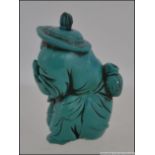 An unusual 20th century Turquoise figural snuff bottle of a man holding a fish. Measures: 6cms high.