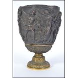 A 19th century Continental gilt metal and bronze neo - classical vessel goblet being cast in relief