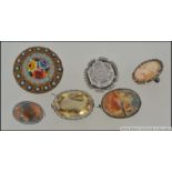 A collection of ladies silver brooches to include cameo set,