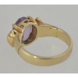 A 9ct gold hallmarked cloudy amethyst ladies dress ring having a bucke style ring.