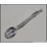 A silver hallmarked ladies brooch in the form of a spoon complete in a leather Murray Ward for