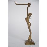 A 1930's Art Deco brass pocket watch stand holder in the form of a maiden with hook atop,